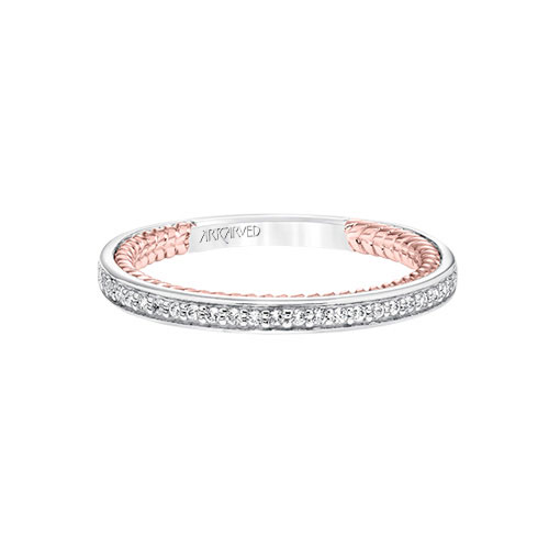 The diamonds go all around the wedding band on this ArtCarved beauty.