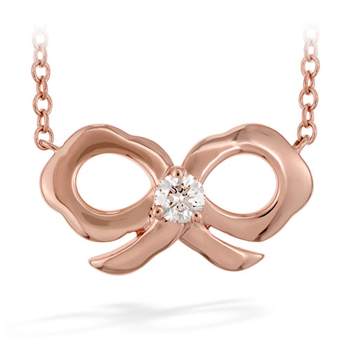 A cute little diamond is in the middle of this rose gold bow pendant.