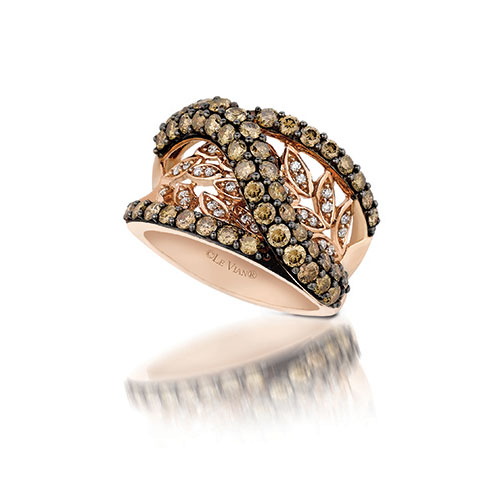 This diamond ring has an open design and features white and chocolate diamonds.